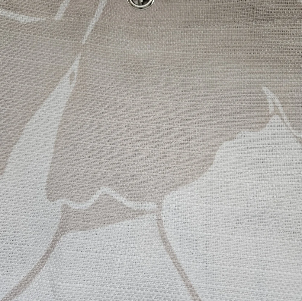 Floral tan and ivory fabric shower curtain with satin nickel hooks.